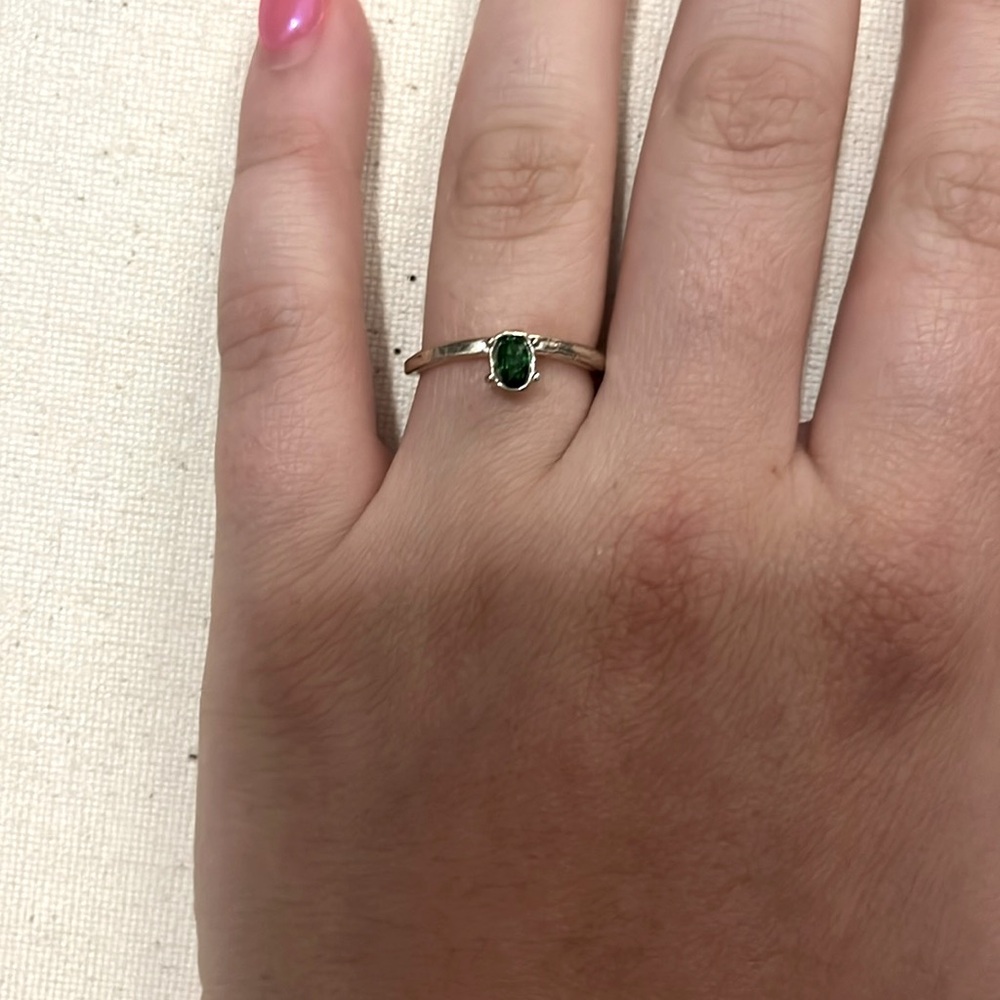 silver ring with green stone in center